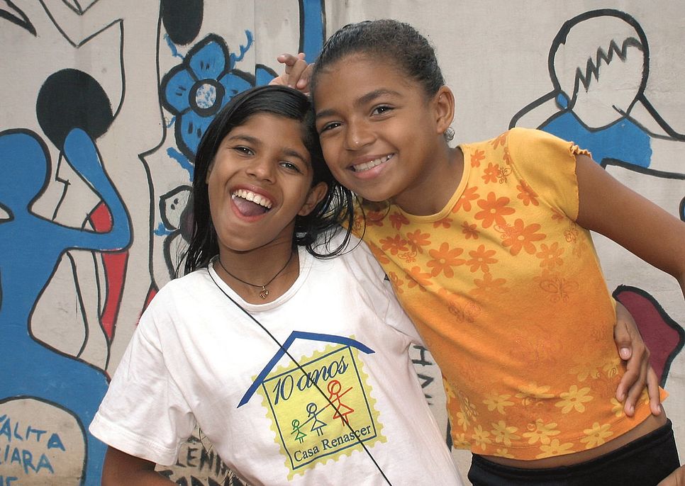 Zwei brasilianische Mädchen lachen in die Kamera.